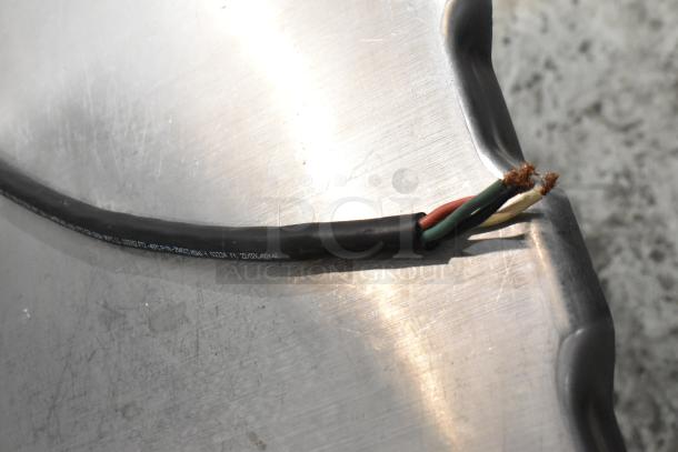 Close-up of the Hobart 6801 Commercial Meat Saw cable, showing exposed internal wiring on a metallic surface.