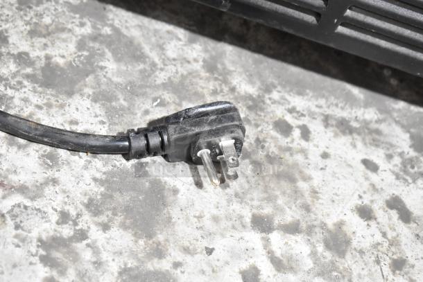 2019 Habco SE18HC commercial cooler cord with a grounded three-prong plug on a concrete floor, visible dust.