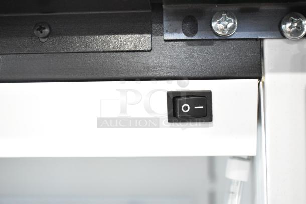 Close-up image of the Habco SE18 cooler's power switch on a white panel, showing an on/off button and metal screws.