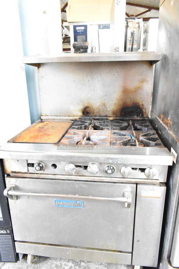 Imperial commercial gas 4-burner range with flat top griddle, oven, overshelf, backsplash, on casters; used condition.