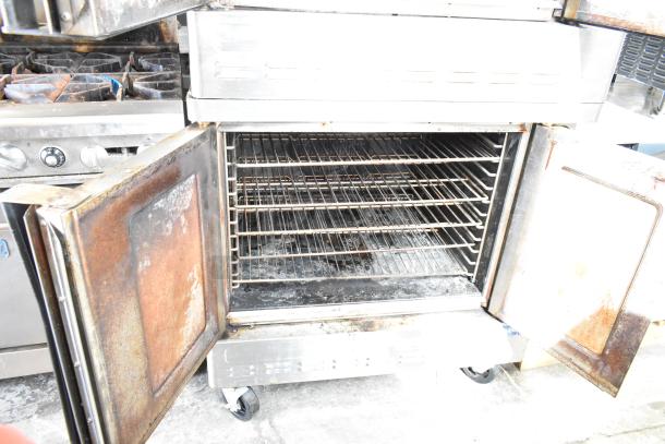 Blodgett DFG-100-3 convection oven, full-size, view-through doors, thermostatic controls, used condition on casters.