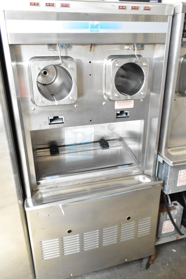 Taylor commercial 2-flavor frozen beverage machine, stainless steel, on casters, 208/240V, 1 phase. Good condition.