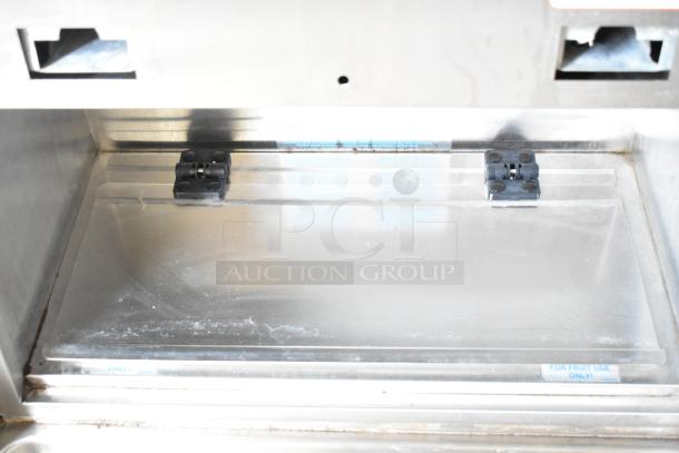 Taylor 2 flavor frozen beverage machine on commercial casters, 208/240 volts, 1 phase. Clean condition with "For Fruit Use Only" label.