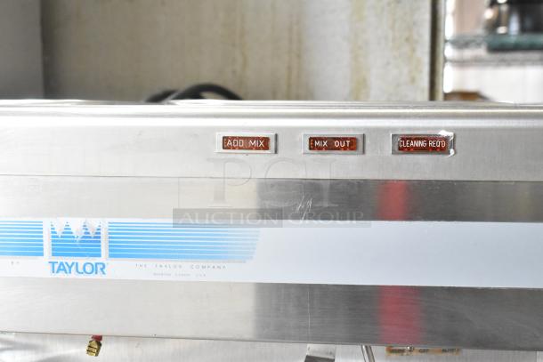 Taylor Commercial 2 Flavor Frozen Beverage Machine, stainless steel, on casters, 208/240V, 1 Phase, with status indicators.