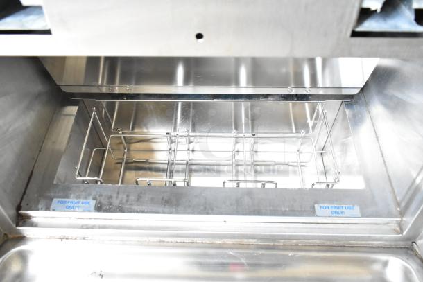 Taylor 2-flavor frozen beverage machine interior view, stainless steel, with "FOR FRUIT USE ONLY" label, on commercial casters.