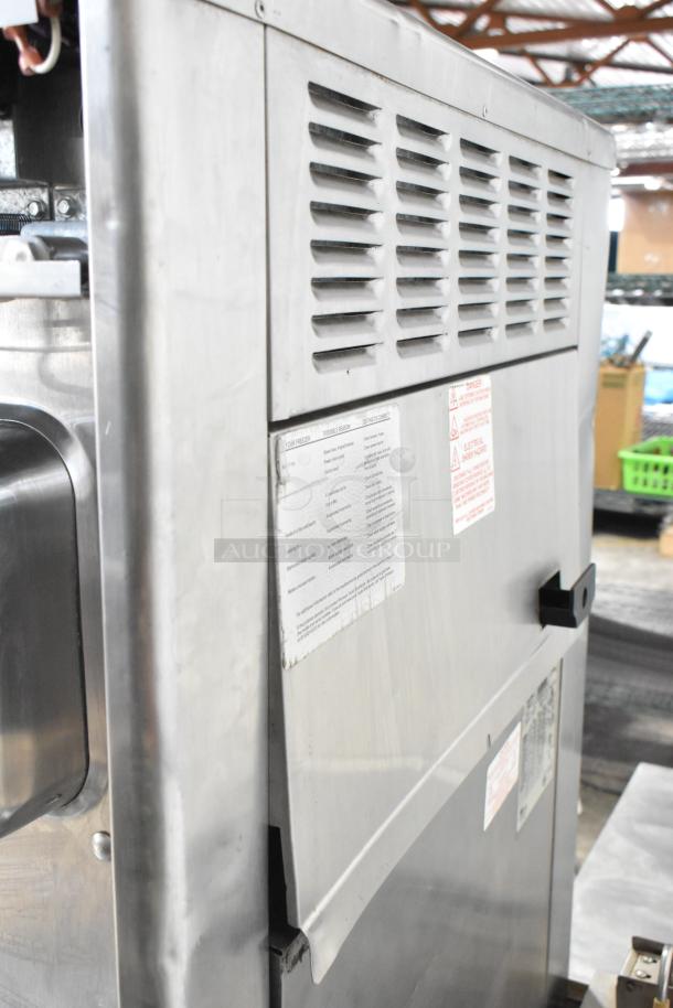 Taylor 342D-27 commercial floor-style 2-flavor frozen beverage machine on casters. 208/240V, 1 Phase. Labels visible.