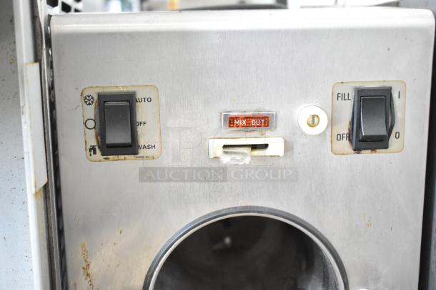 Taylor commercial countertop single flavor frozen beverage machine, stainless steel, 115V, signs of use, "Mix Out" indicator.