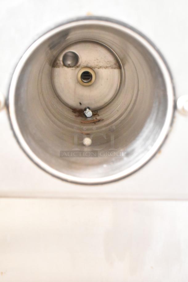 Inside view of Taylor Commercial Countertop Single Flavor Frozen Beverage Machine, showing the stainless steel interior and spout.