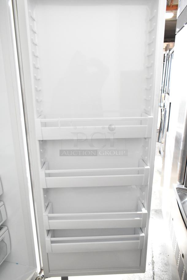 Viking Reach-In Cooler with Freezer, 115 volts, 1 phase. Features door shelves, white interior, good condition.