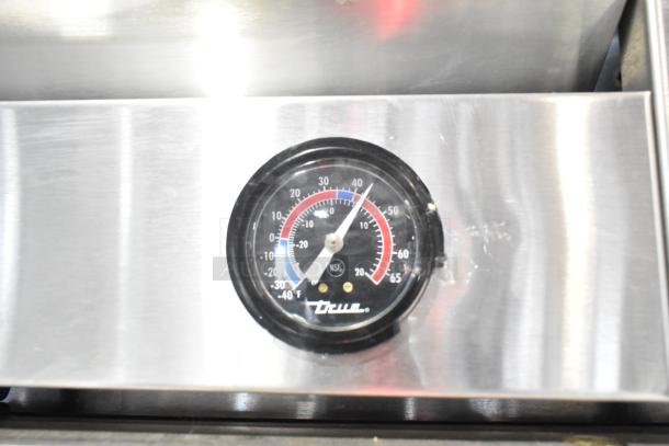 Thermometer gauge of 2016 True T-19F commercial freezer, shows temperature in Fahrenheit, branded with True logo.