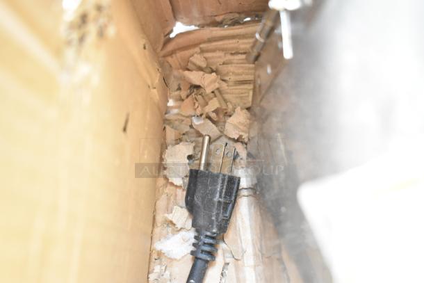 Teruisi YY-MY15 vegetable cutter in packaging, showing a 110V power cord amidst cardboard padding.