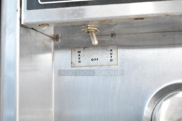Taylor commercial countertop single flavor frozen beverage machine with wash, off, and auto settings, showing some wear.