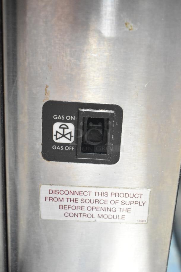 Blodgett commercial convection oven with view-through door, solid door, and thermostatic controls. Visible gas on/off switch and safety label.
