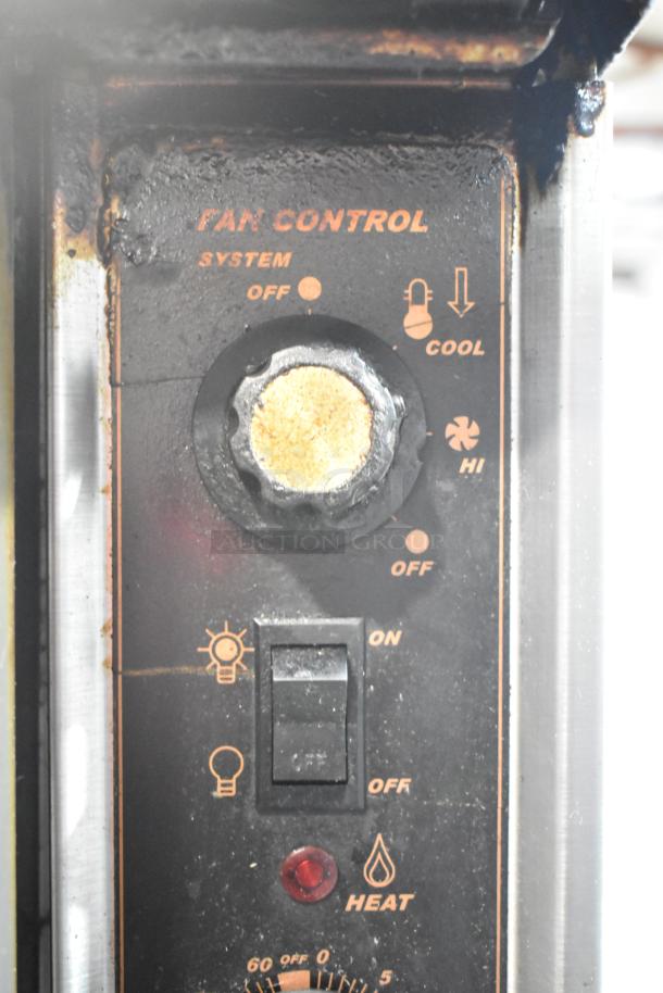 "Montague convection oven control panel with settings for system, fan speed, light, and heat, showing wear."