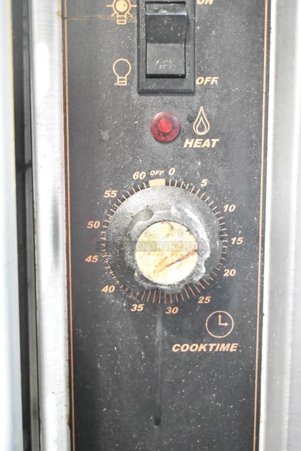 Montague convection oven control panel with light switch, heat indicator, and cooktime dial.