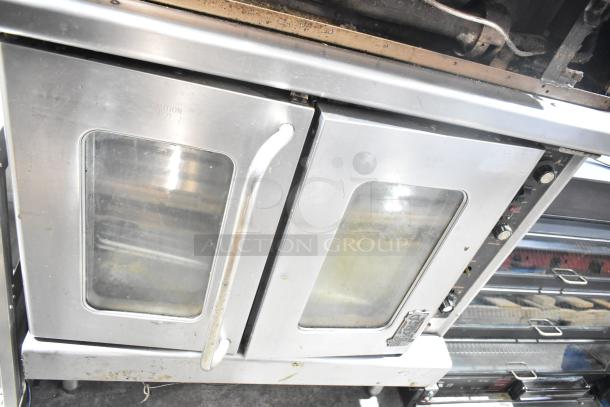 "Montague commercial gas-powered convection oven with view-through doors and thermostatic controls, full-size, stainless steel finish."