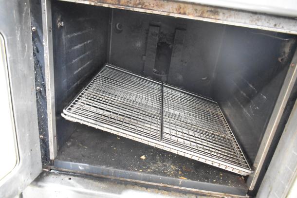 Montague commercial convection oven interior, visible wire rack, used condition, gas-powered, view-through doors.