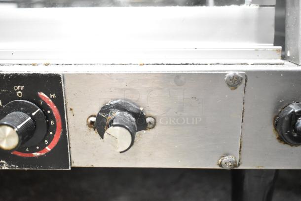 Hatco Commercial Countertop 2 Tier Warming Display Case control knobs, showing wear and rust on stainless steel panel.