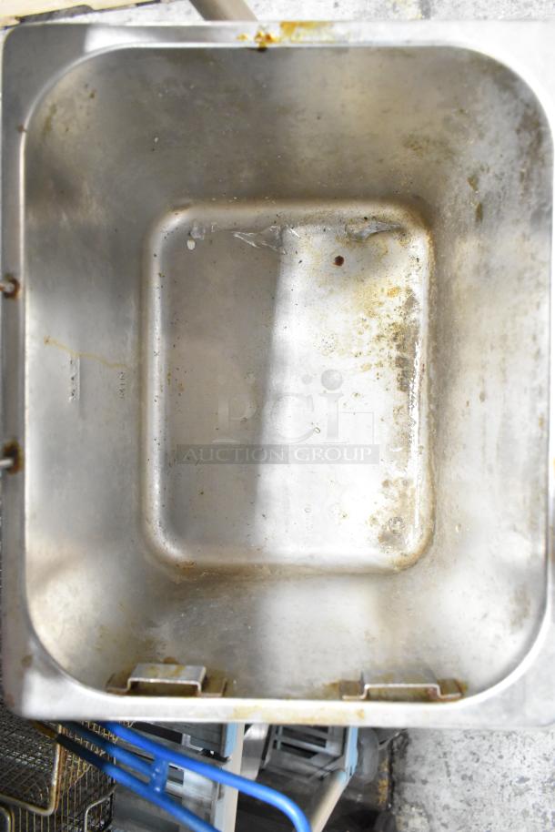 Set of 2 fryer drop-in bins and 2 fry baskets, showing interior wear, ideal for commercial kitchen use.