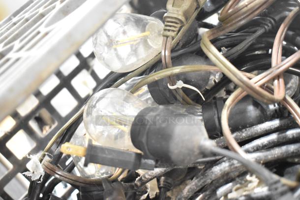 Lot of items including tangled string lights and light fixture. Bulbs are clear, sockets are black. Used condition.