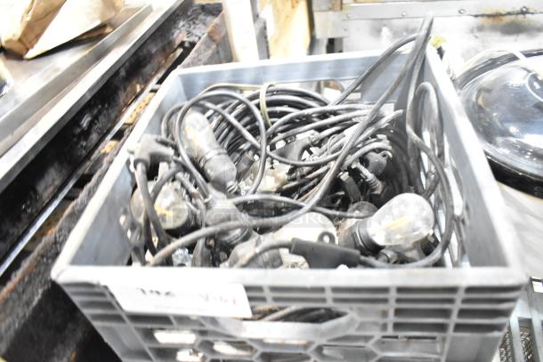 Crate filled with tangled light strings and bulbs, used condition. Includes light fixtures, various items.