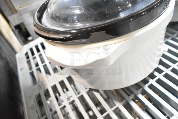 Two slow cookers, including Rival 3950 and Crock Pot SCV803-SS, on metal shelving. 120 volts, 1 phase.