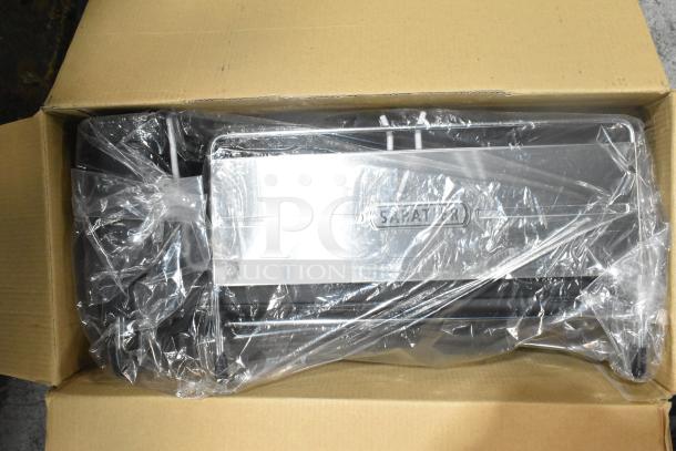 Brand new Sabatier expandable dish rack in original packaging, slight scratches visible.