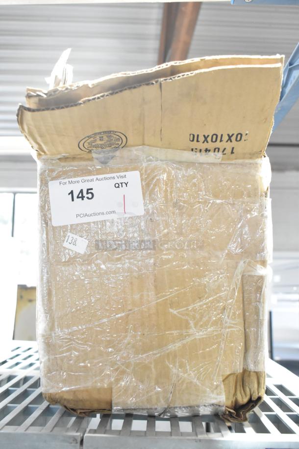 Cardboard box wrapped in plastic, labeled with auction lot number 145, containing water filter cartridge and Aladdin black trays.