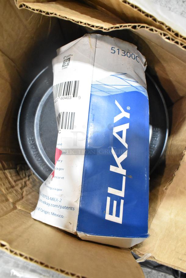Elkay water filter replacement cartridge in original packaging; Aladdin Temp-Rite black poly trays visible beneath. Condition appears unused.