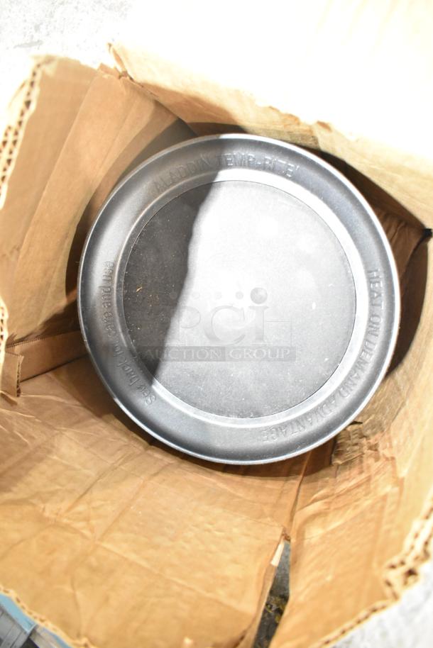 Cardboard box containing Aladdin Temp-Rite black poly tray; visible embossed brand and care instructions.