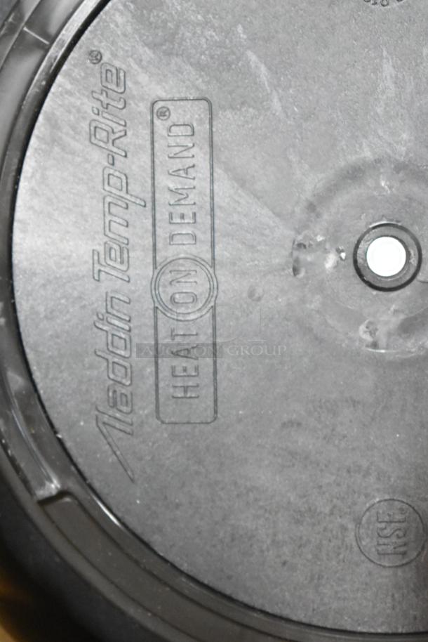 Aladdin Temp-Rite black poly tray with "Heat On Demand" marking, circular design, likely new condition.