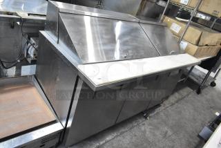 True TSSU-72-30M-B-ST commercial sandwich salad prep table, stainless steel, on casters, medium condition.