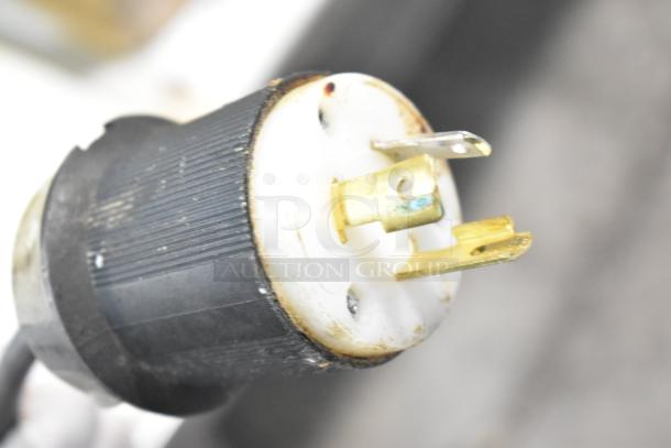 Close-up of a power plug for True TSSU-72-30M-B-ST sandwich prep table, showing prongs and connector details.