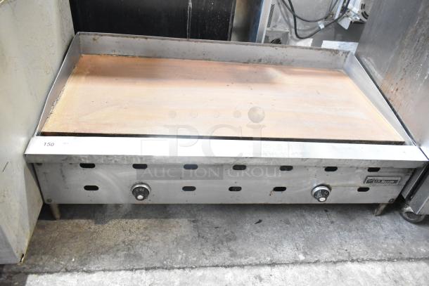 US Range commercial countertop gas-powered flat top griddle with dual control knobs, in used condition.