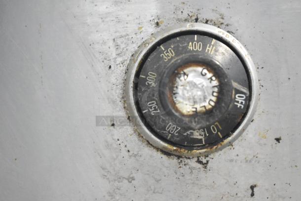 US Range Commercial Gas Griddle thermostat dial, showing temperature settings from 150 to 450°F, with signs of wear.