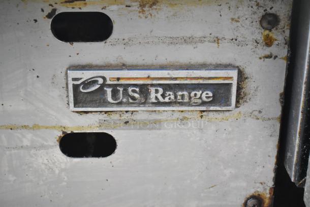 US Range Commercial Gas Flat Top Griddle with visible brand logo, showing signs of wear and use.