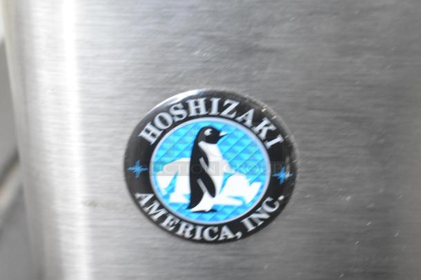 Hoshizaki DCM-300BAH icemaker badge detail. Features a penguin logo, signifies commercial-grade quality.