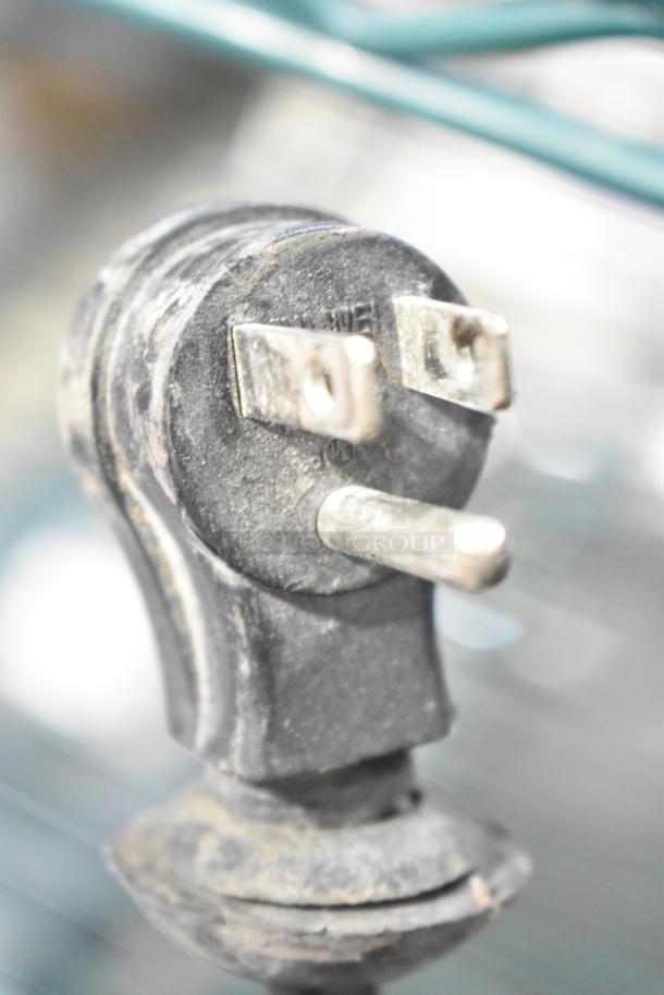 A close-up image of a 115 Volt plug for a Coldline CFD-2RR-E-HC commercial reach-in cooler.