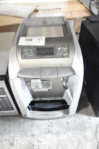 LavAzza Pininfarina LB2312 espresso machine, 120 volts, countertop model, silver finish, auction tag visible.
