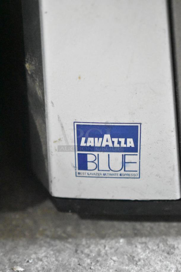 LavAzza Pininfarina LB2312 espresso machine, white finish, "LavAzza Blue" label, 120 volts, minor surface wear visible.