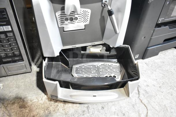 LavAzza Pininfarina LB2312 countertop espresso machine with drip tray, visible spouts, and steam wand. 120V, 1 phase.