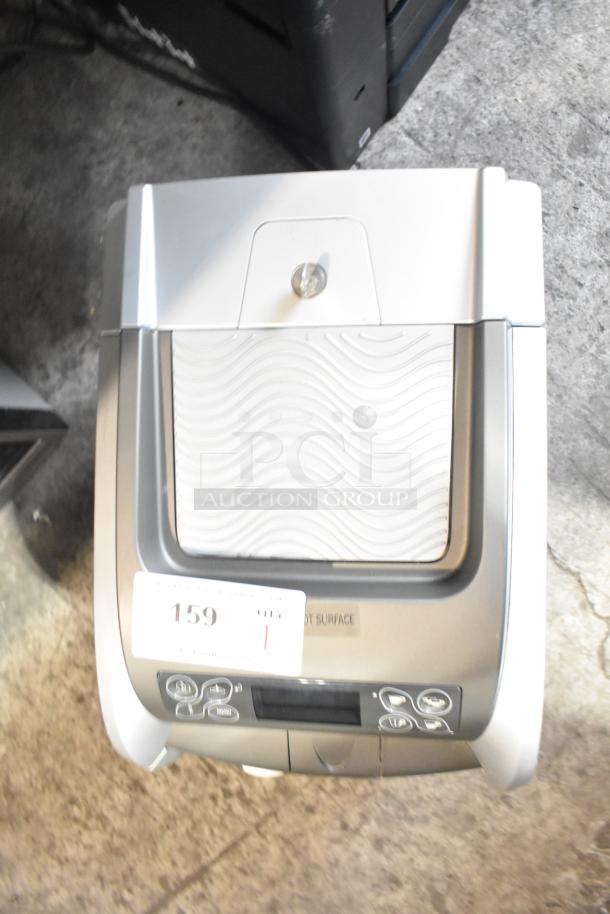 LavAzza Pininfarina LB2312 countertop espresso machine, 120V, features push-button controls, appears in good condition.