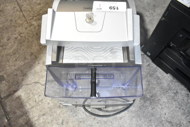 LavAzza Pininfarina LB2312 countertop espresso machine, 120 volts, showing top view with key slot and transparent tray.