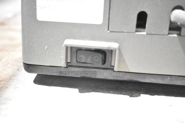 LavAzza Pininfarina LB2312 espresso machine on/off switch close-up; 120 volts, 1 phase; grey casing; minor wear.