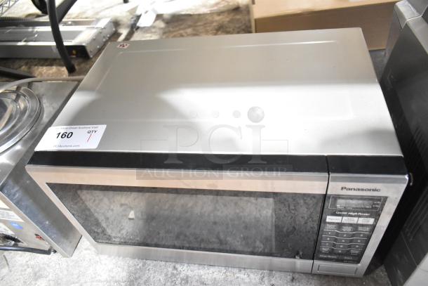 2018 Panasonic NN-SA651S countertop microwave oven, stainless finish, keypad on right, auction label on top.