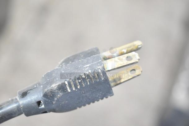 A close-up of the power plug for the Gold Medal 2191 Countertop Cheese Warmer, showing signs of wear.