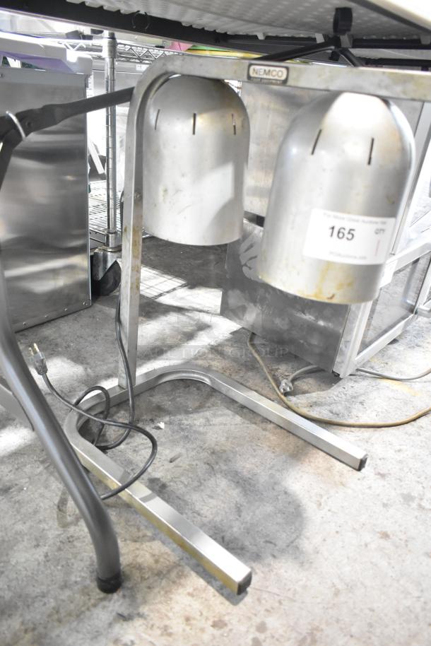 Nemco 6000A-2 countertop lamp warmer with two heads, 120 volts, visible wear, auction tag affixed.