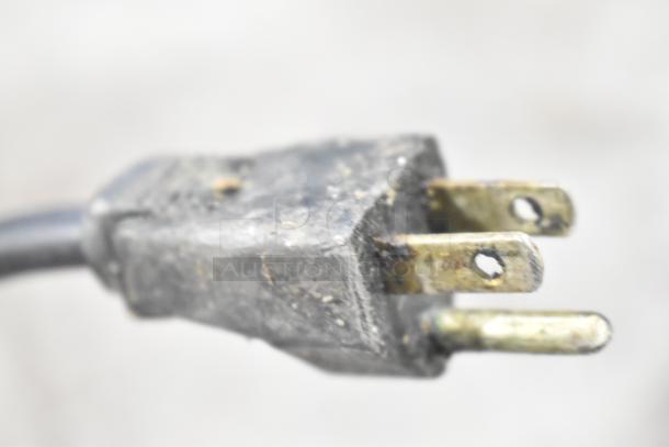 Close-up of a 3-prong plug on the Nemco 6000A-2 lamp warmer cord, showing some wear. 120 Volts, 1 Phase power.