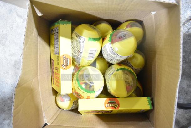 10 boxes of assorted candy, including Reeses, visible in open cardboard box, with labels showing nutrition info.