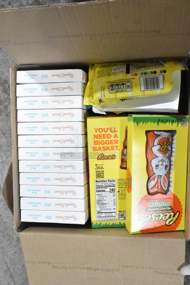 Box of assorted candies including Russell Stover chocolates, Reese's chocolate bunny, and Peeps chocolate pudding.